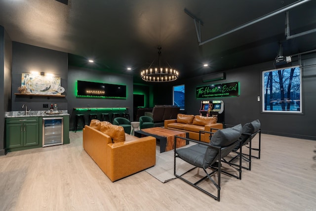 cinema with an AC wall unit, wet bar, wine cooler, and light hardwood / wood-style flooring