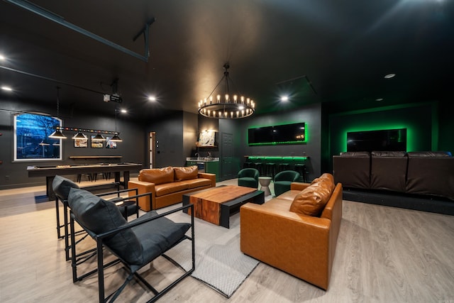 home theater room with wood-type flooring and bar area