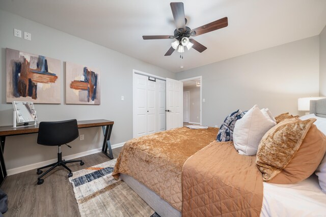 bedroom with ceiling fan, wood-type flooring, and a closet