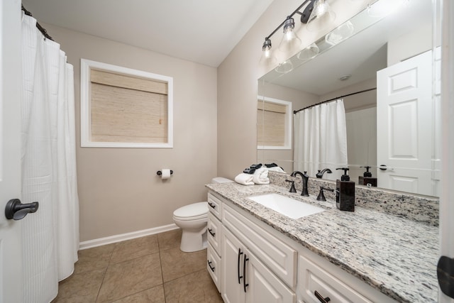 bathroom featuring tile patterned flooring, vanity, and toilet