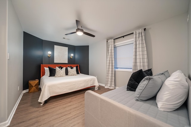 bedroom featuring hardwood / wood-style flooring and ceiling fan