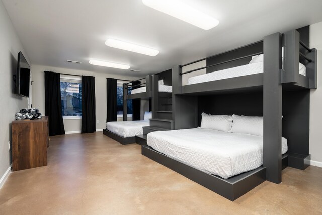 bedroom featuring concrete floors