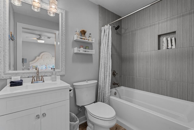 full bathroom featuring toilet, shower / bath combo with shower curtain, and vanity