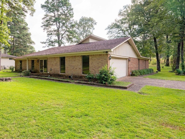 ranch-style house with a garage and a front yard