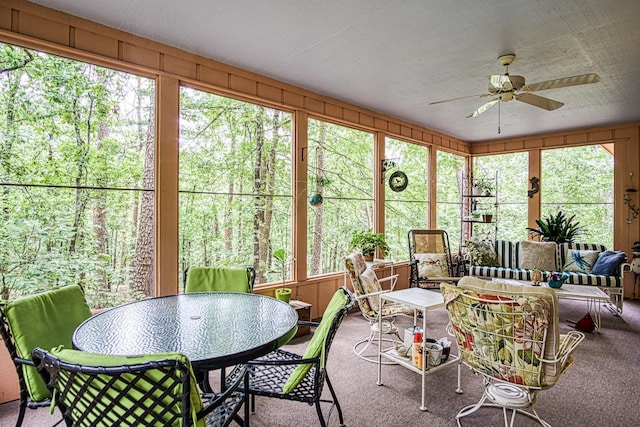 sunroom featuring ceiling fan