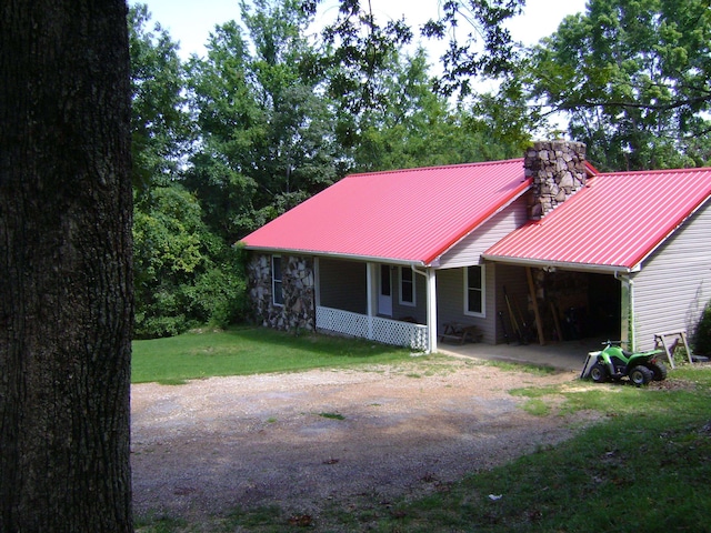 rear view of property with a yard and covered porch