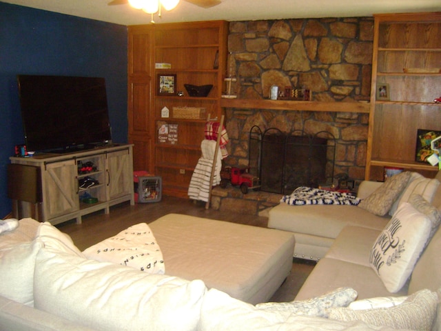 living room featuring hardwood / wood-style flooring, a fireplace, and ceiling fan