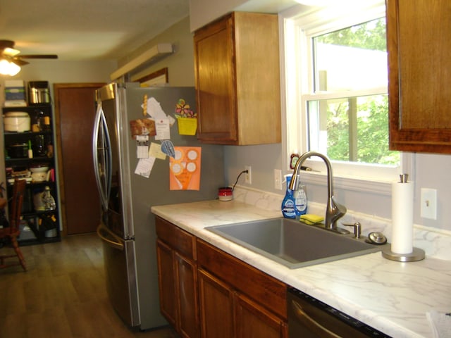 kitchen featuring dishwasher, ceiling fan, dark hardwood / wood-style floors, stainless steel fridge, and sink