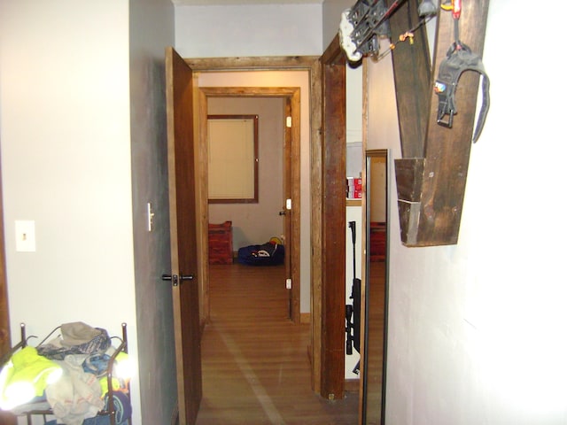 corridor with hardwood / wood-style floors