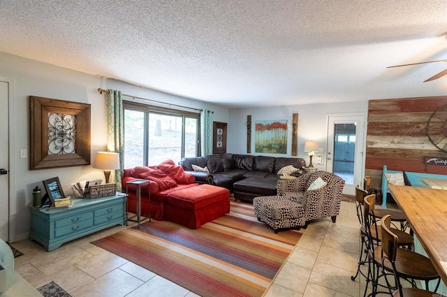 tiled living room featuring a textured ceiling and ceiling fan