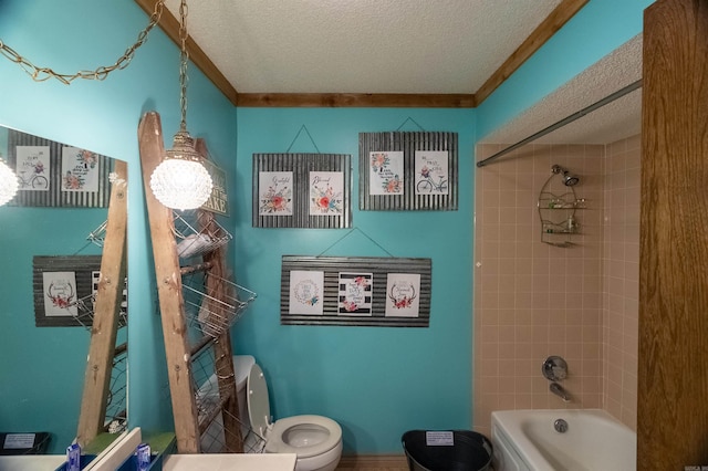 bathroom featuring tiled shower / bath combo, toilet, and a textured ceiling