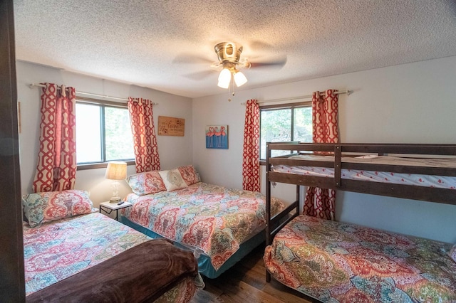 bedroom featuring ceiling fan, a textured ceiling, and hardwood / wood-style flooring