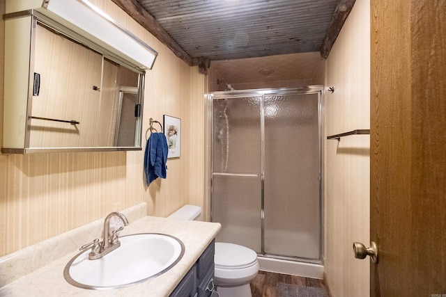 bathroom featuring vanity, hardwood / wood-style flooring, toilet, a shower with door, and wood ceiling