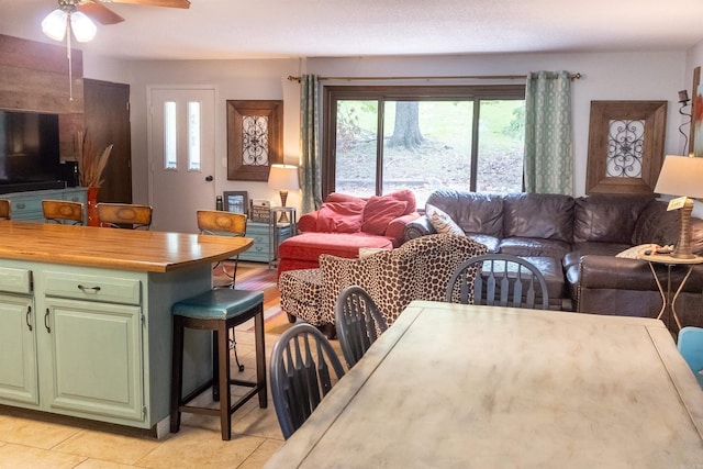 tiled living room featuring ceiling fan