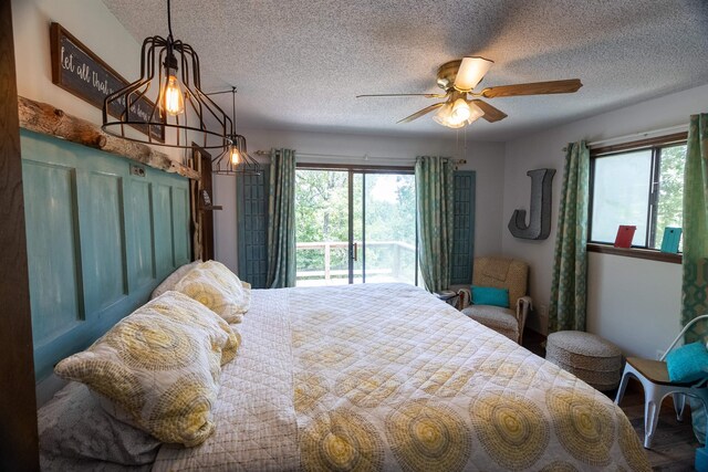 bedroom with a textured ceiling, access to outside, hardwood / wood-style flooring, and ceiling fan