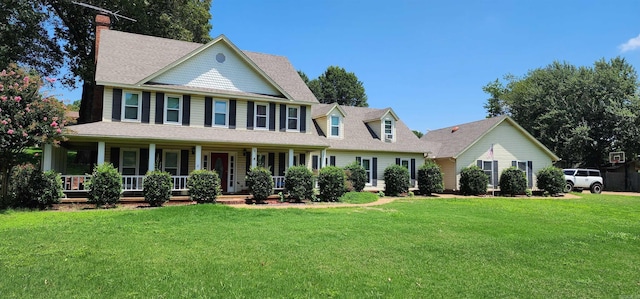 view of front of home with a porch and a front lawn