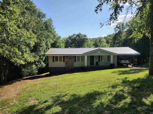 ranch-style home featuring a carport and a front yard