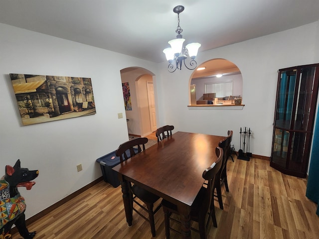 dining room featuring hardwood / wood-style flooring and a chandelier