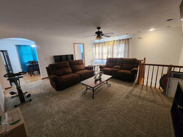 carpeted living room with ceiling fan