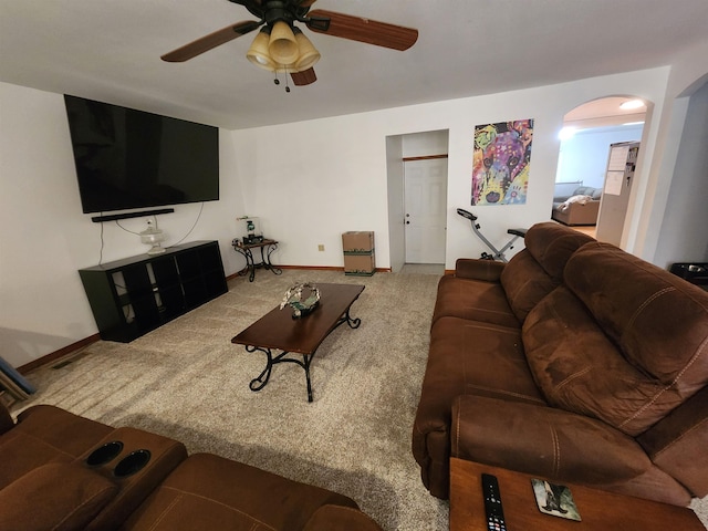 carpeted living room with ceiling fan