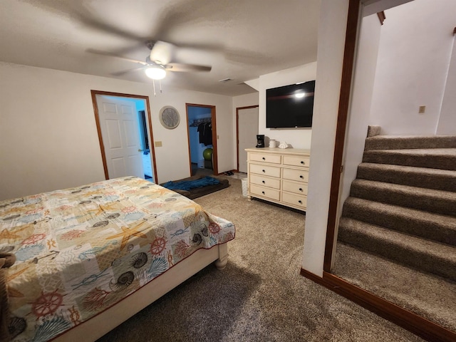 bedroom featuring dark colored carpet, ceiling fan, and a closet