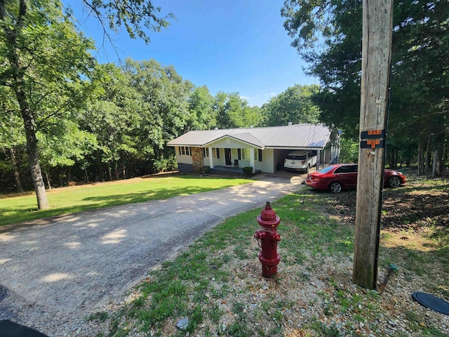 ranch-style home featuring a carport and a front lawn