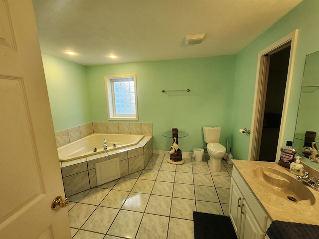 bathroom featuring a relaxing tiled tub, tile patterned floors, toilet, and vanity