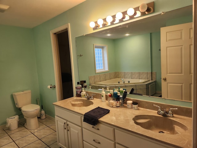 bathroom featuring vanity, a washtub, tile patterned floors, and toilet