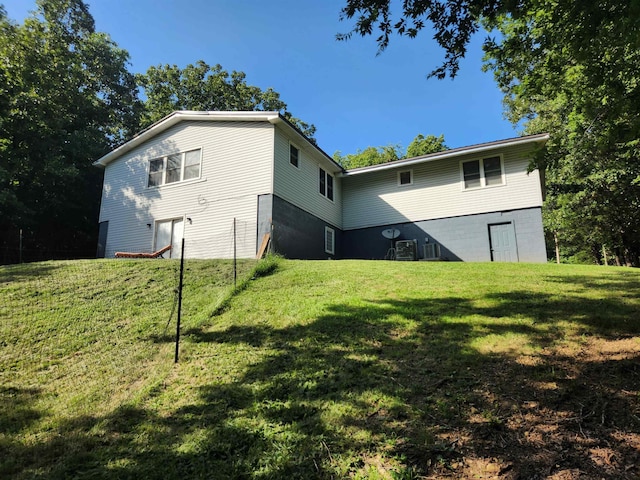 rear view of property featuring a yard