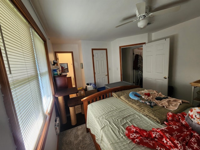 carpeted bedroom with multiple windows and ceiling fan