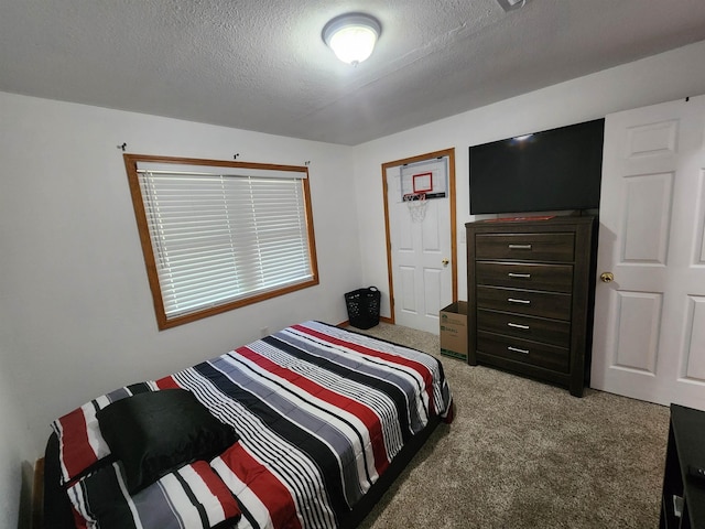 bedroom featuring carpet flooring and a textured ceiling