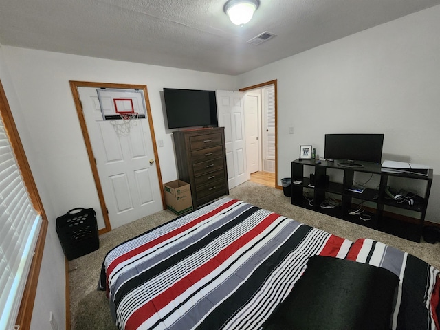 carpeted bedroom with a textured ceiling