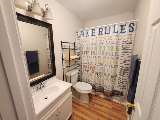 bathroom with vanity, hardwood / wood-style floors, and toilet