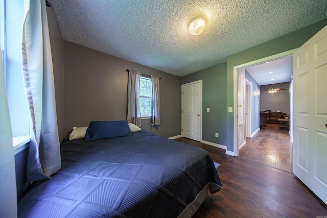 bedroom with wood-type flooring and a textured ceiling