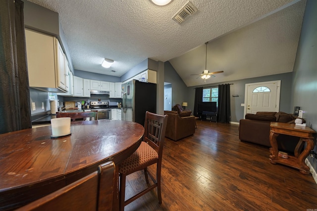 dining space with dark hardwood / wood-style floors, a textured ceiling, vaulted ceiling, and ceiling fan