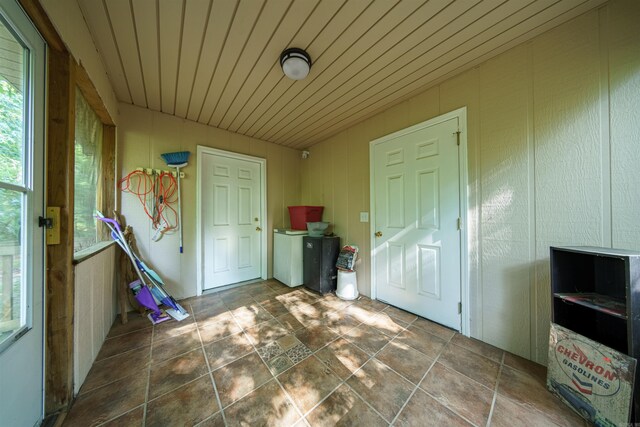 tiled foyer entrance with wooden ceiling