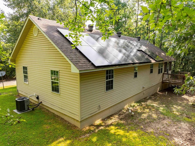 back of house with a lawn and cooling unit