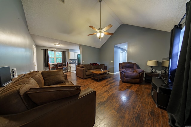 living room featuring ceiling fan, hardwood / wood-style flooring, and vaulted ceiling