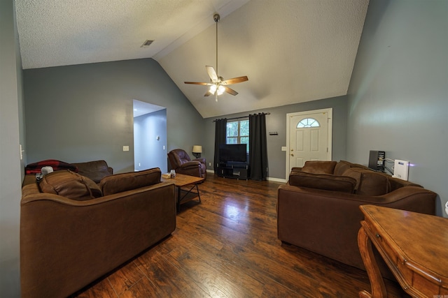 living room featuring a textured ceiling, vaulted ceiling, dark hardwood / wood-style flooring, and ceiling fan