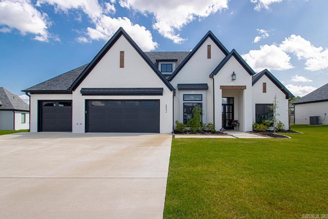 view of front of house featuring a garage, a front lawn, and cooling unit