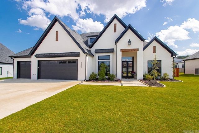 view of front of property with a garage and a front lawn