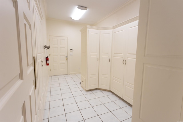 interior space featuring light tile patterned floors and crown molding