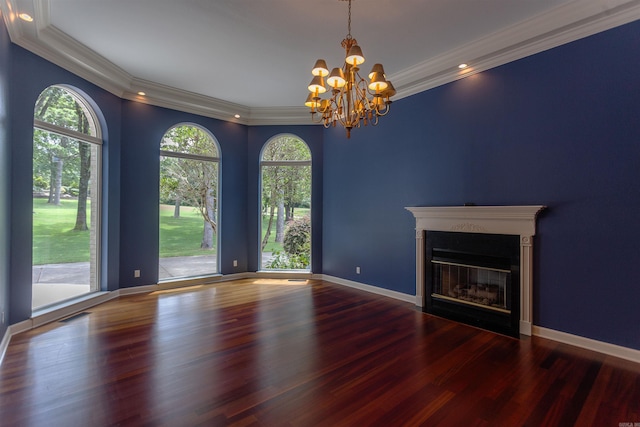 unfurnished living room with baseboards, visible vents, a fireplace with flush hearth, ornamental molding, and wood finished floors