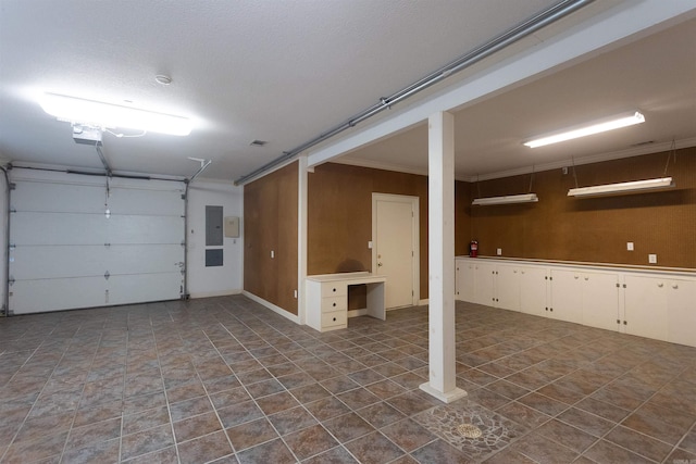 garage featuring electric panel and a garage door opener