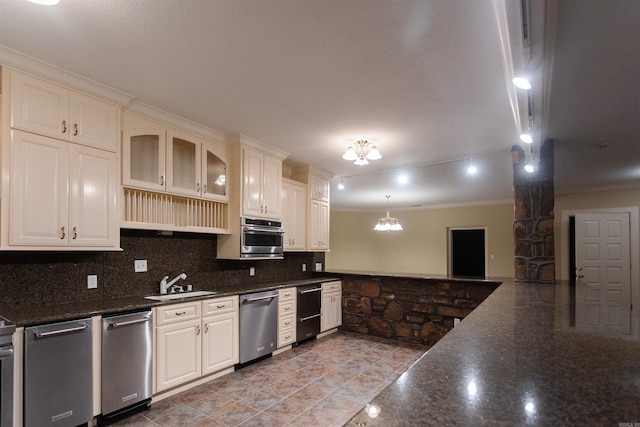 kitchen featuring crown molding, backsplash, appliances with stainless steel finishes, glass insert cabinets, and a sink