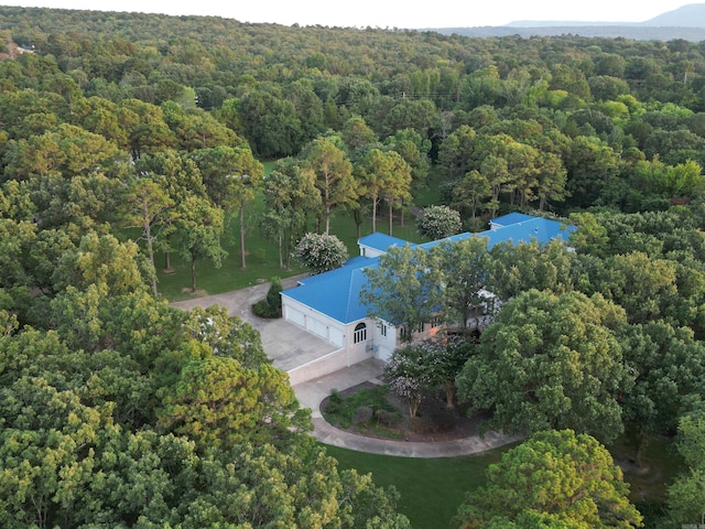 drone / aerial view featuring a forest view