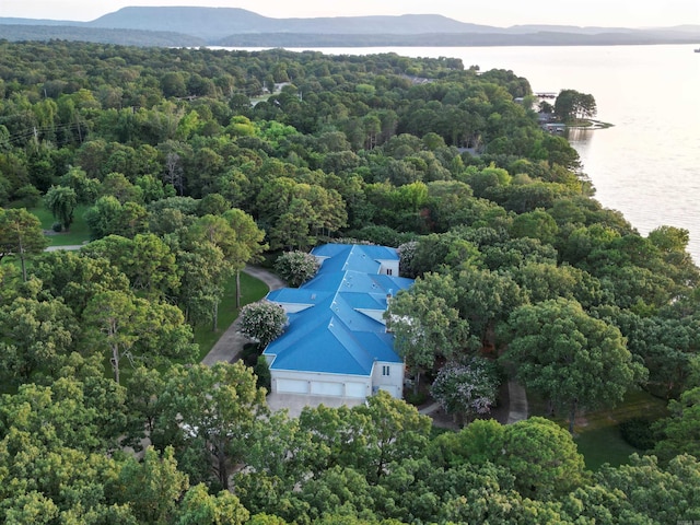 aerial view with a wooded view and a water and mountain view