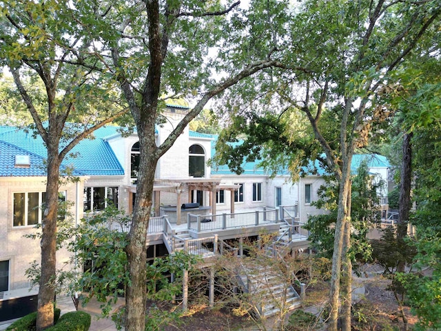 back of house featuring a deck, stairway, and a pergola