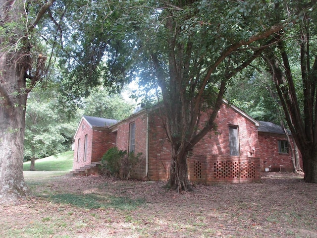 view of side of property with brick siding