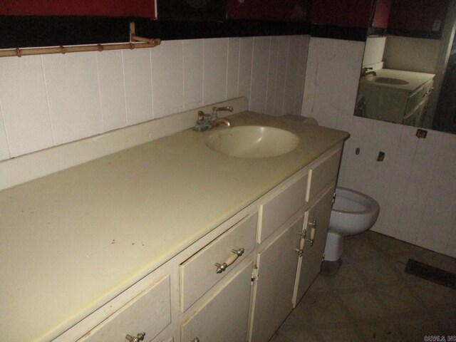 bathroom with vanity, toilet, and tile patterned flooring